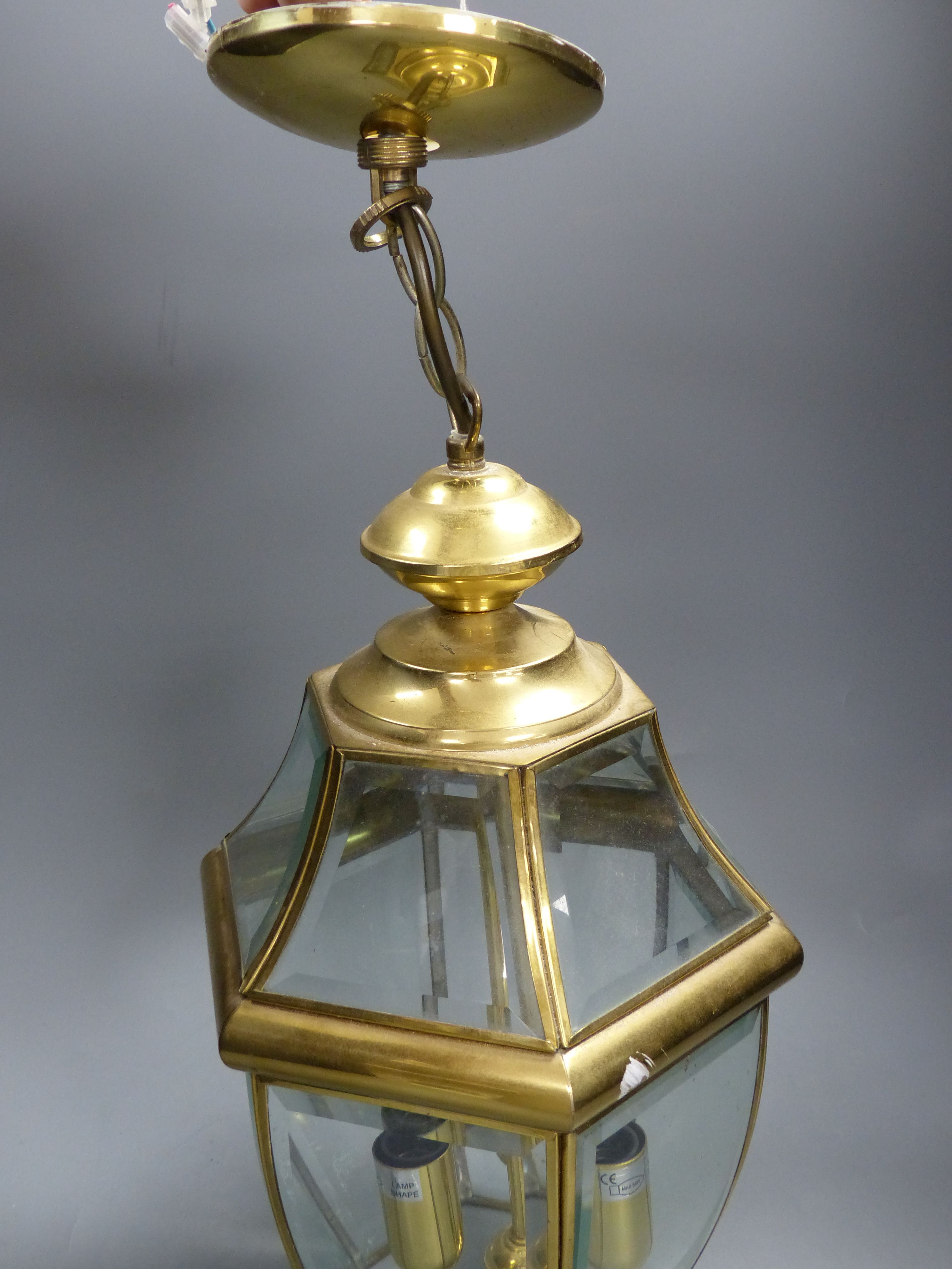 A hexagonal gilt metal and glass hall lantern
